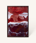 Abstract art piece in a dark wooden frame featuring deep red and white fluid patterns reminiscent of ocean waves or stormy clouds, with marbled textures creating a dramatic contrast between the colors.